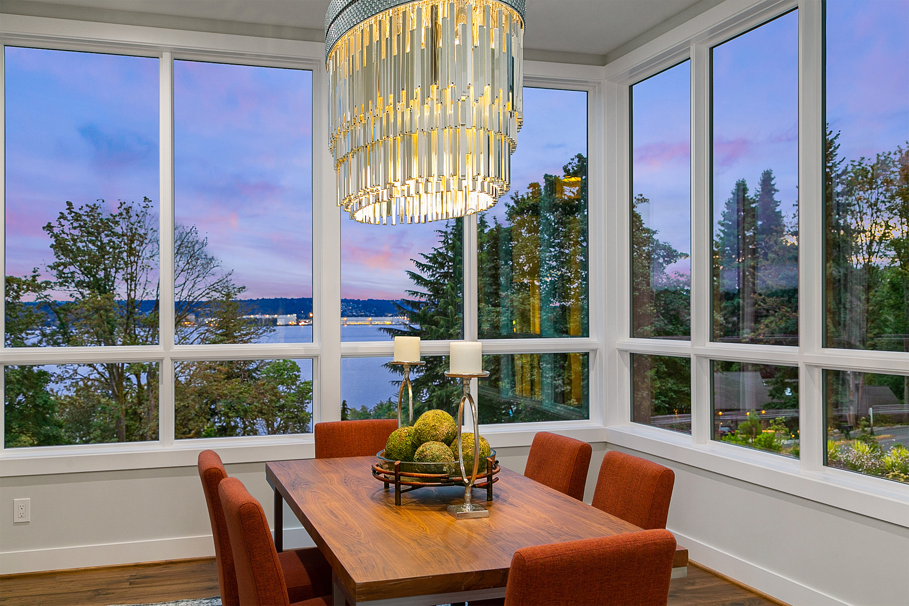 Dining room with wraparound windows and a chandelier