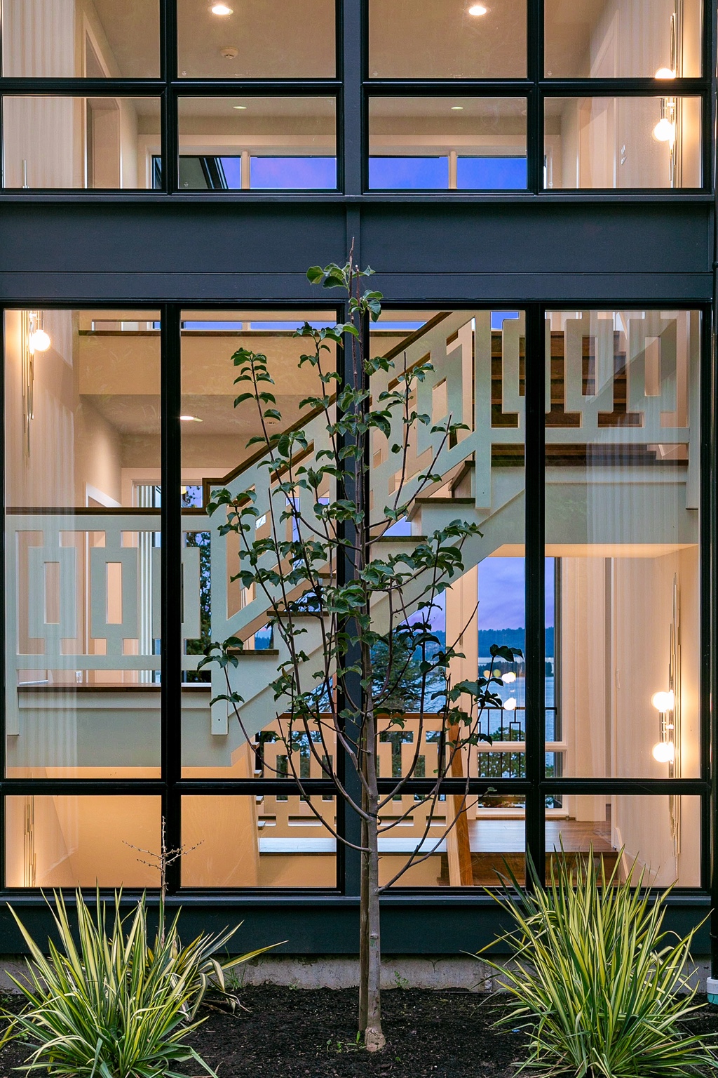 Staircase and geometric railing seen through the glazed facade