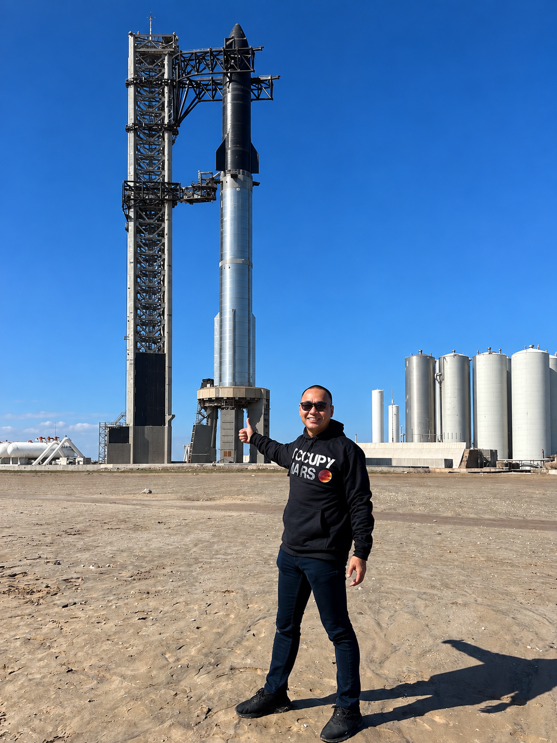 Titus Howe in front of Starship and its launch tower, November 2023